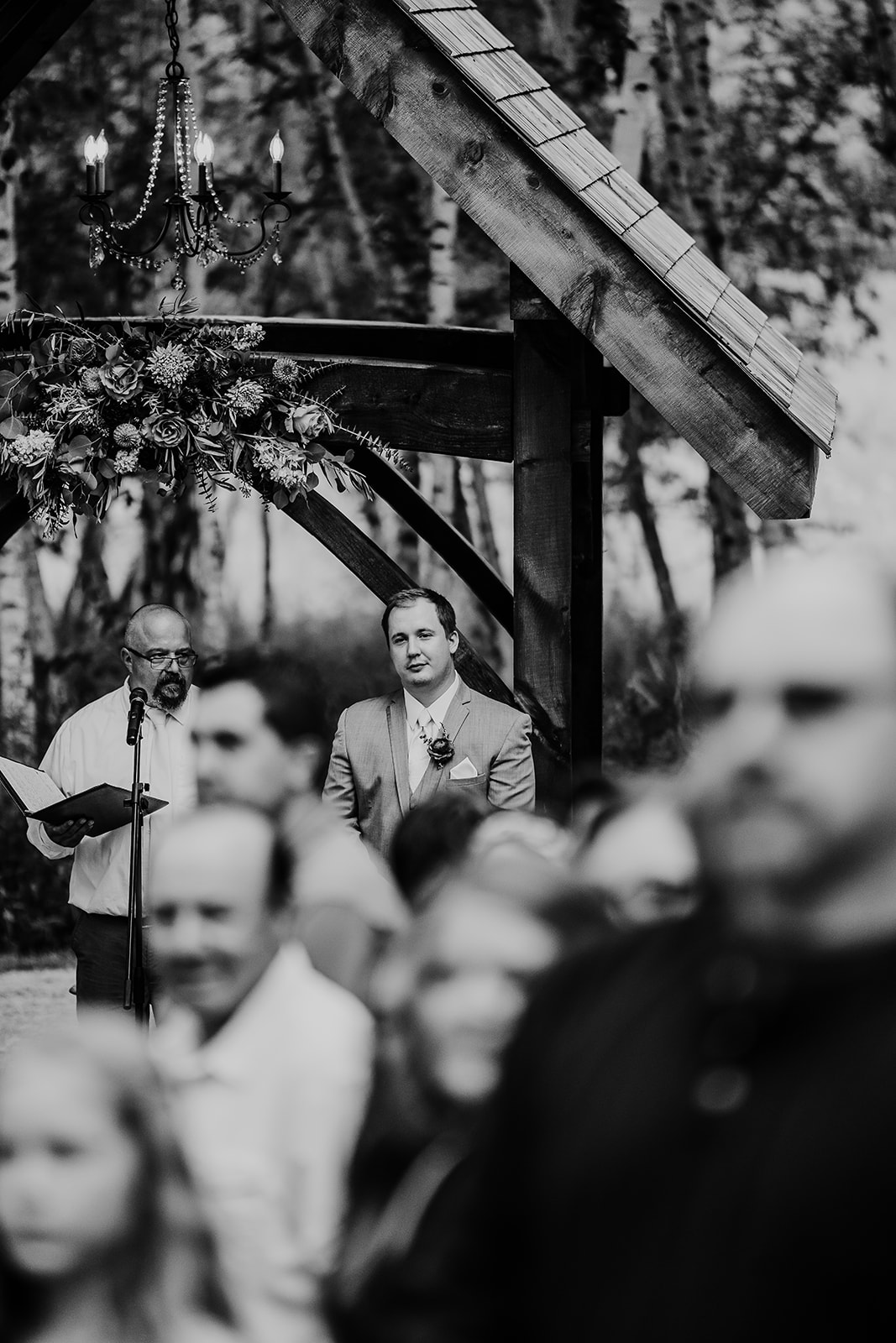 A Wisconsin groom sees his bride walking down the aisle. Chippewa valley wedding Apple orchard wedding Black and white wedding photos First look photos #dixonappleorchard #orchardweddingvenue #outdoorwedding #appleorchardwedding #wisconsinweddingvenue
