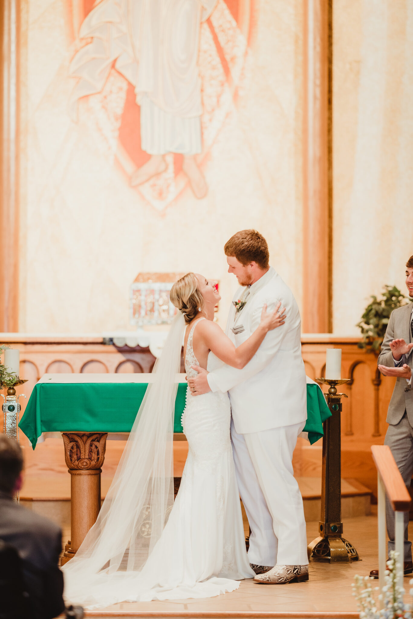 The bride and groom smile in front of their friends and family at the end of their Wisconsin church ceremony. Church wedding ceremony Wedding ceremony photos  #weddingplanning #weddingtimeline #diywedding #wisconsinweddingphotographer #wisconsinchurchwedding
