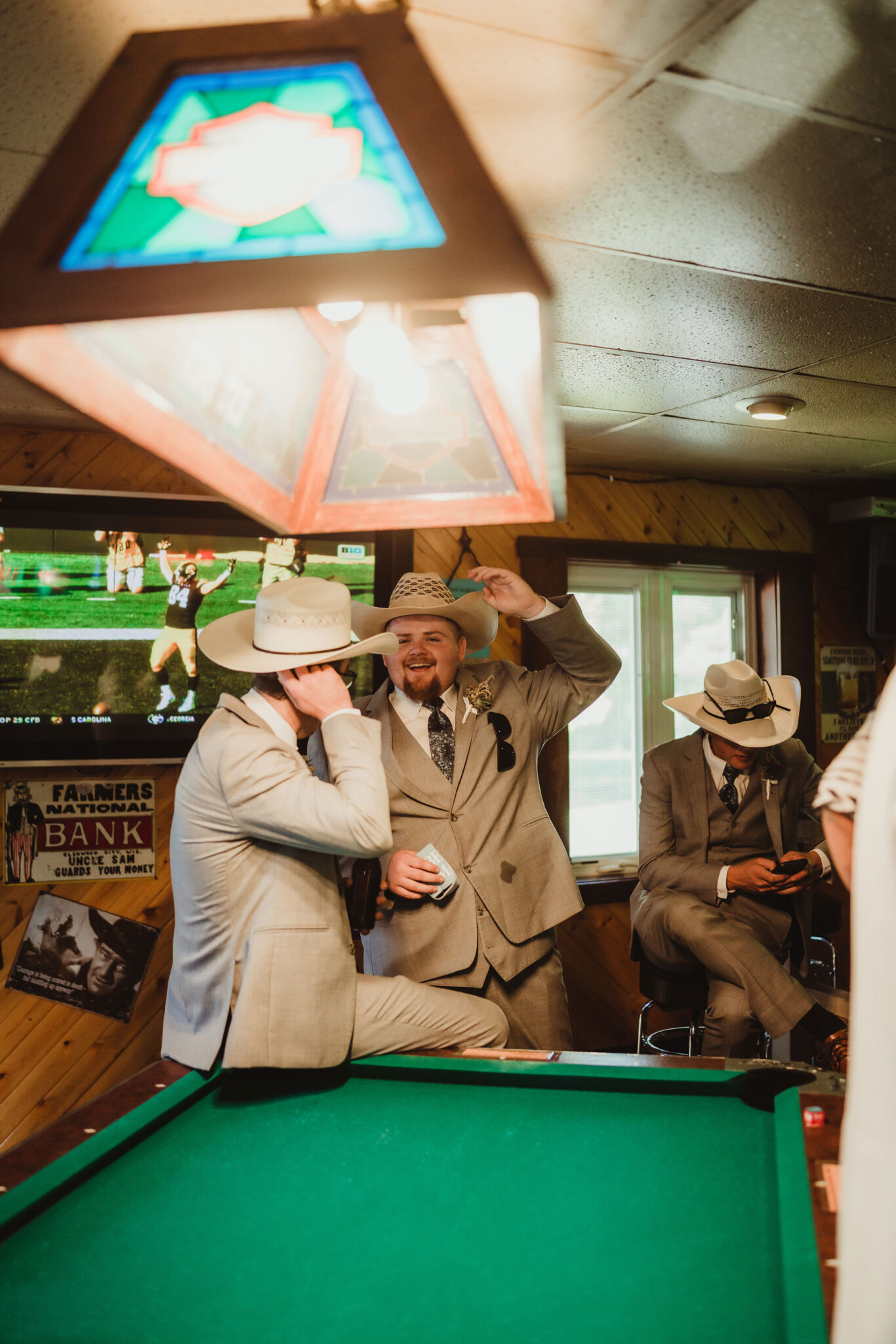 Cowboy groomsmen celebrate together at a Wisconsin wedding venue bar. Cowboy wedding Cowboy hats Groomsmen photos Wisconsin wedding reception #weddingplanning #weddingtimeline #diywedding #wisconsinweddingphotographer #wisconsinchurchwedding