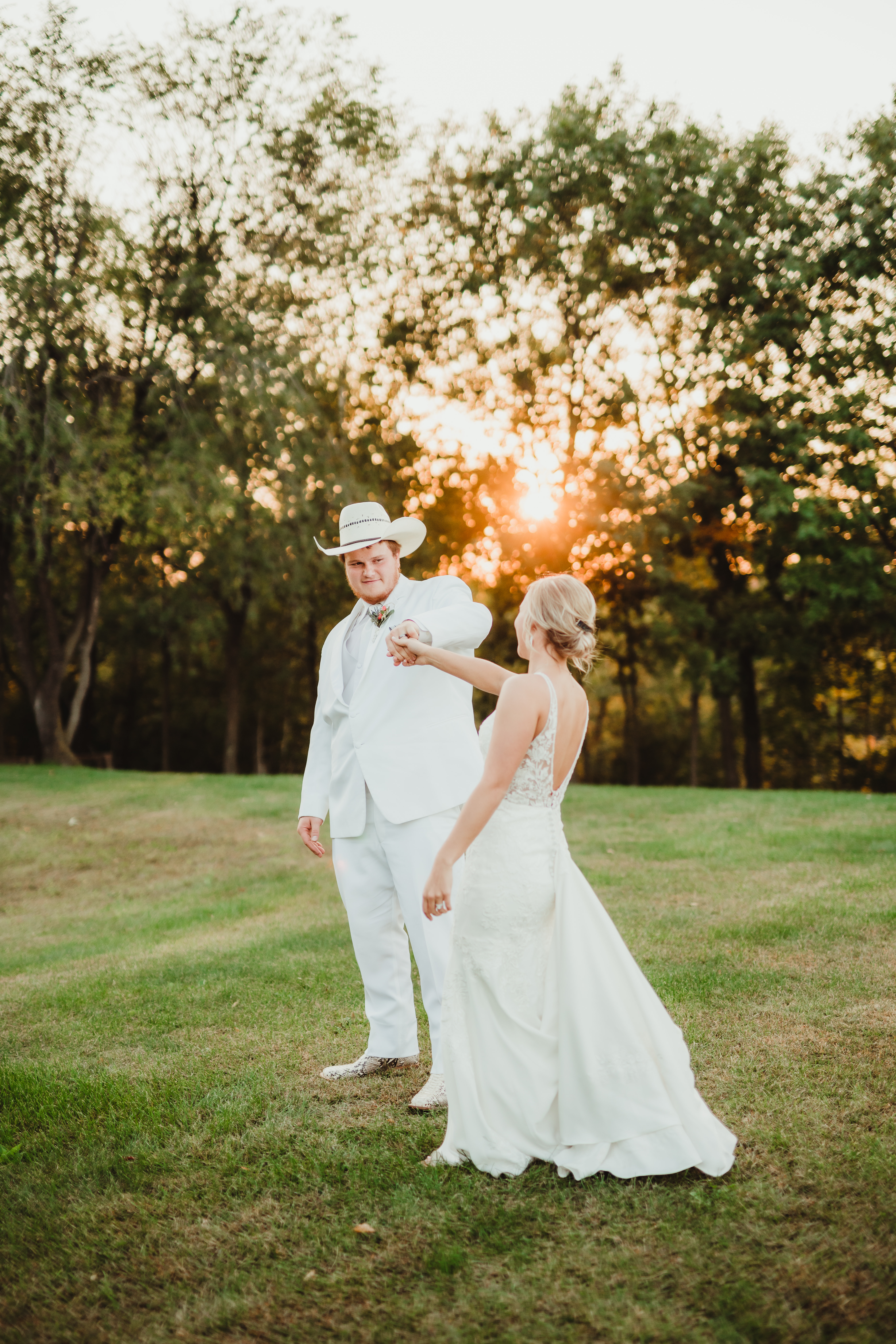 A newlywed couple dances on the lawn of their Wisconsin wedding venue. Bride and groom pose Newlywed photos Cowboy groom Groom outfit inspo #weddingplanning #weddingtimeline #diywedding #wisconsinweddingphotographer #wisconsinchurchwedding
