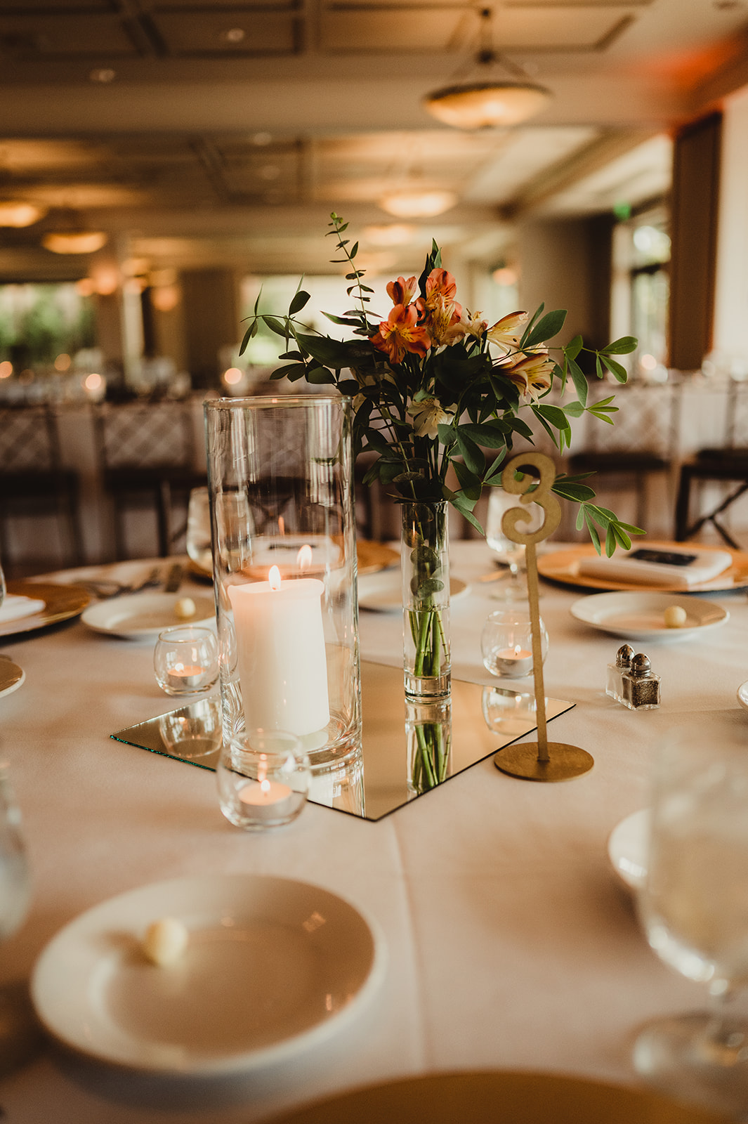 This gorgeous table setting with tall floral centerpieces and candles is perfect reception inspiration for brides. Orange centerpiece Reception table setting Wedding reception inspo #weddinginspiration #weddingplanning #diywedding #wisconsinweddingphotographer #armywedding