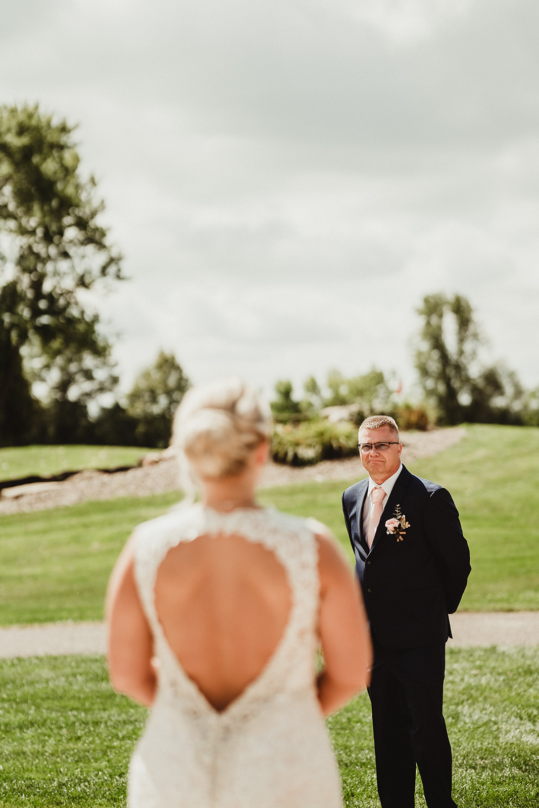 The father of the bride sees his daughter in her wedding gown during an emotional first look session. Father of the bride First look photos Wisconsin bride #wisconsinweddingphotographer #choosingaphotographer #lakesidewedding #waterfrontweddingceremony