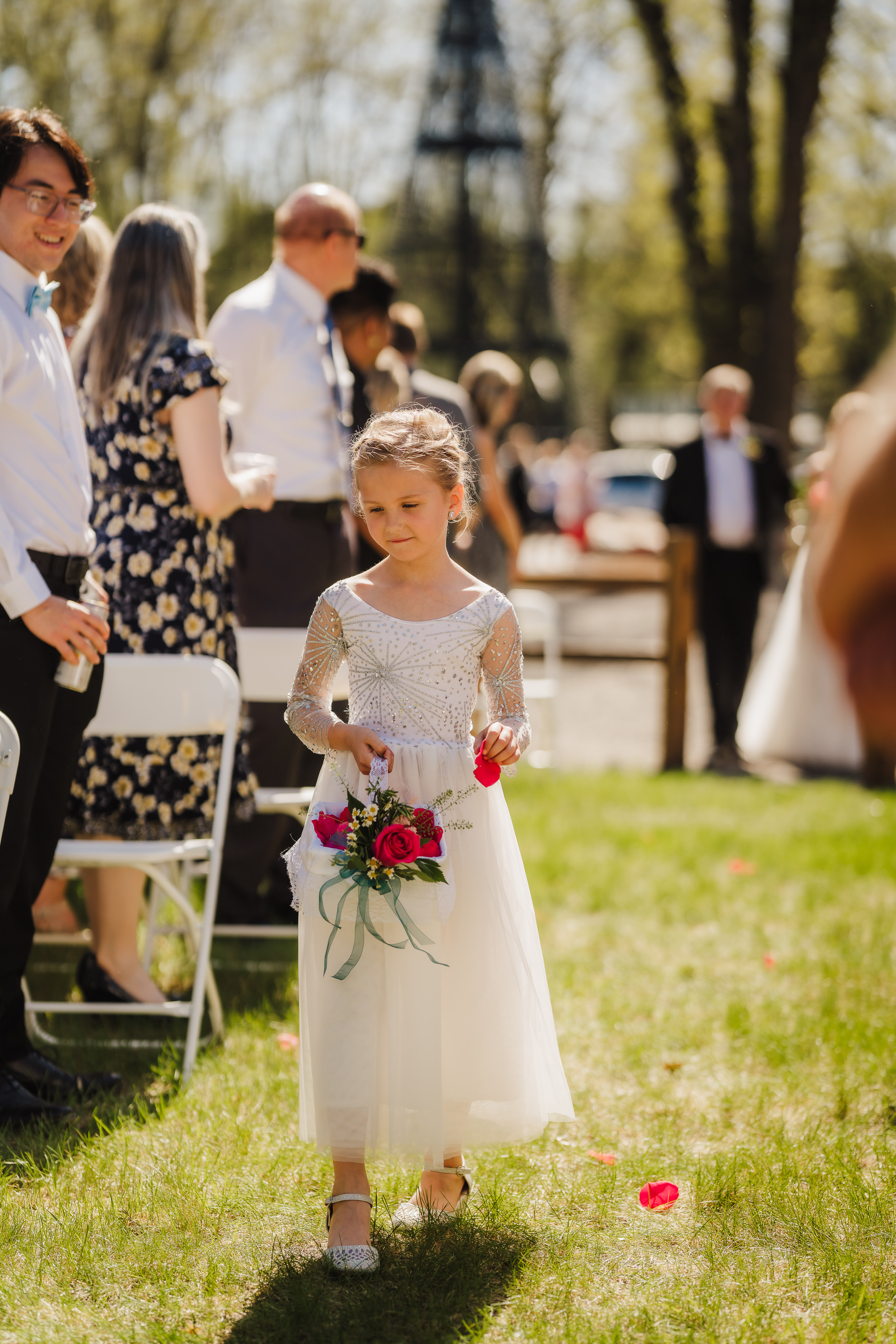A sweet Wisconsin flower girl drops pink rose petals down the aisle in a white flower girl dress. Pink wedding flowers Lace flower girl dress Flower girl inspo #forestgreenwedding #rusticweddingvenue #weddingplanning #wisconsinweddingphotographer #wisconsinweddingvenue
