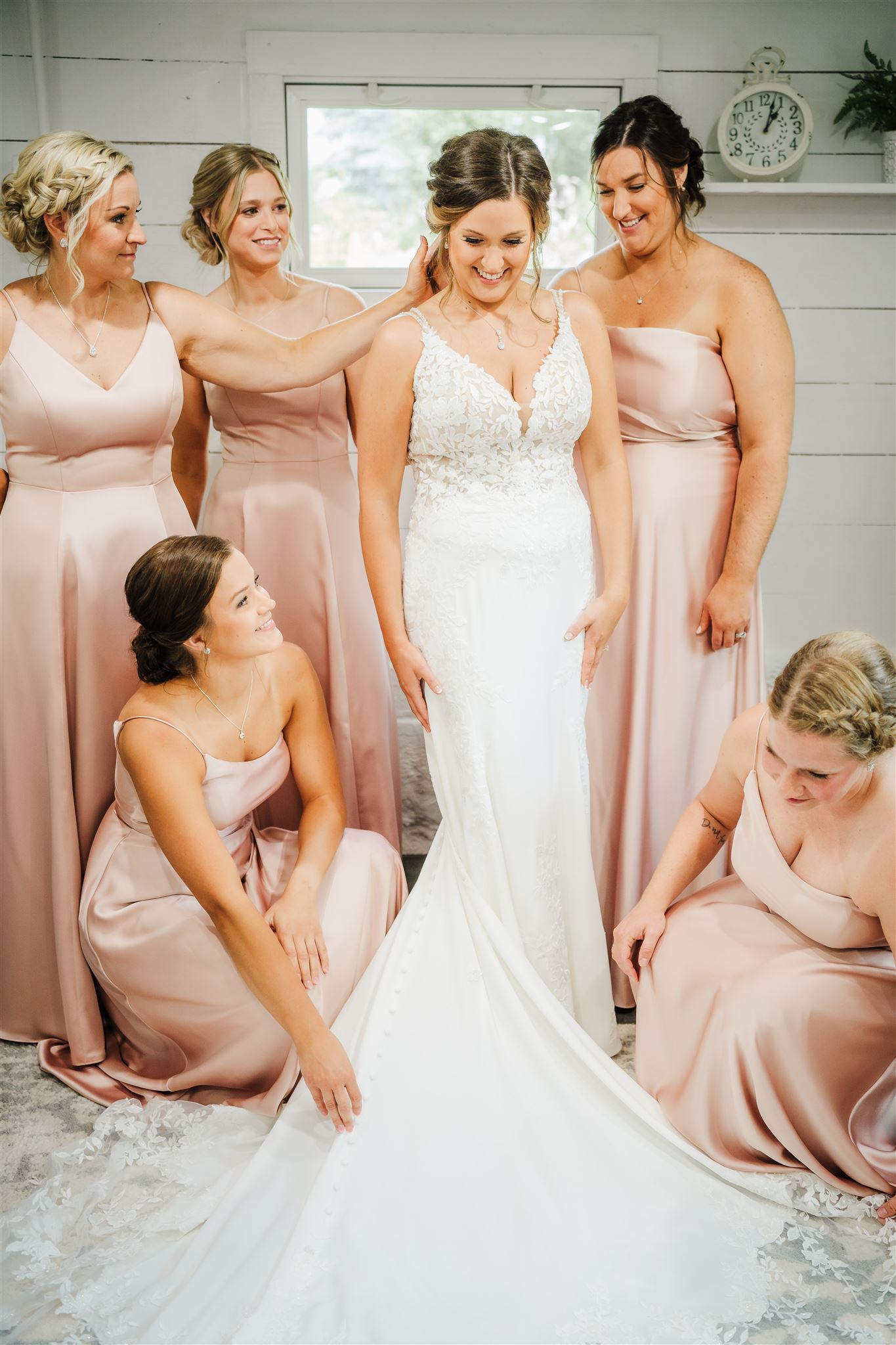 I love to get a photo of the bride getting ready for her wedding day with her bridesmaids fawning over her. Blush pink wedding Bridesmaids photo Getting ready photos #weddinginspiration #weddingplanning #diywedding #wisconsinweddingphotographer #armywedding